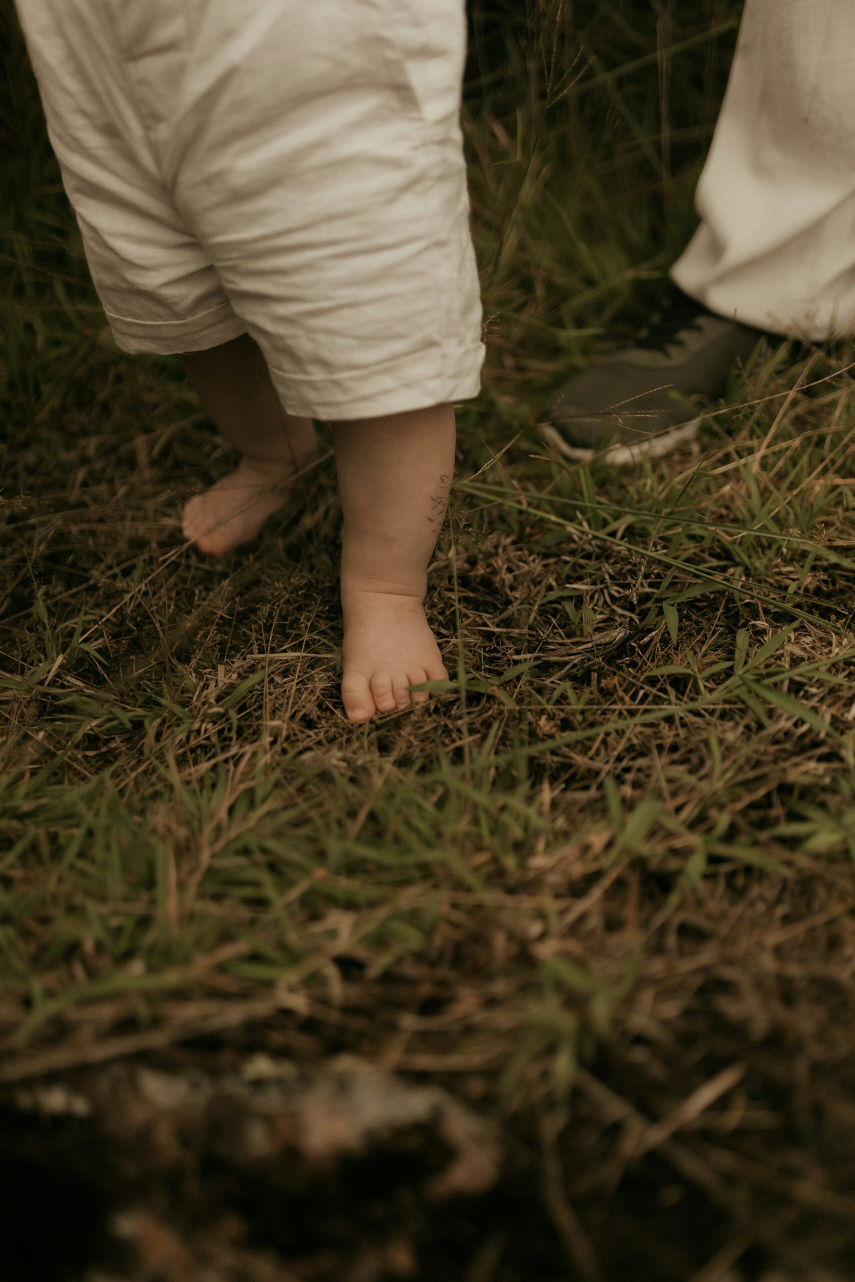 Child taking steps with parent there to see the milestone.