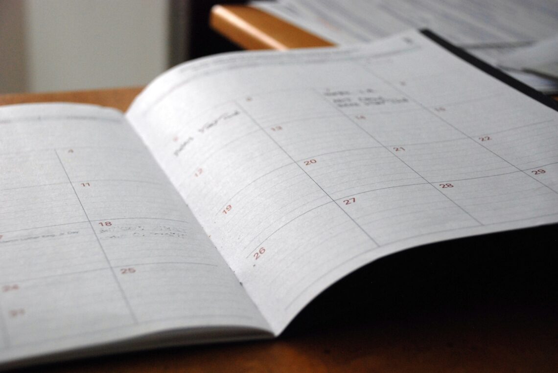 organized planner and calendar representing how long distance parents stay on top of their child's school year