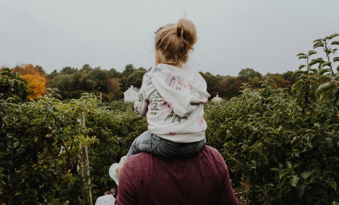 Alt text: "father and young daughter together representing the bond a long distance dad maintains despite the distance and stigma