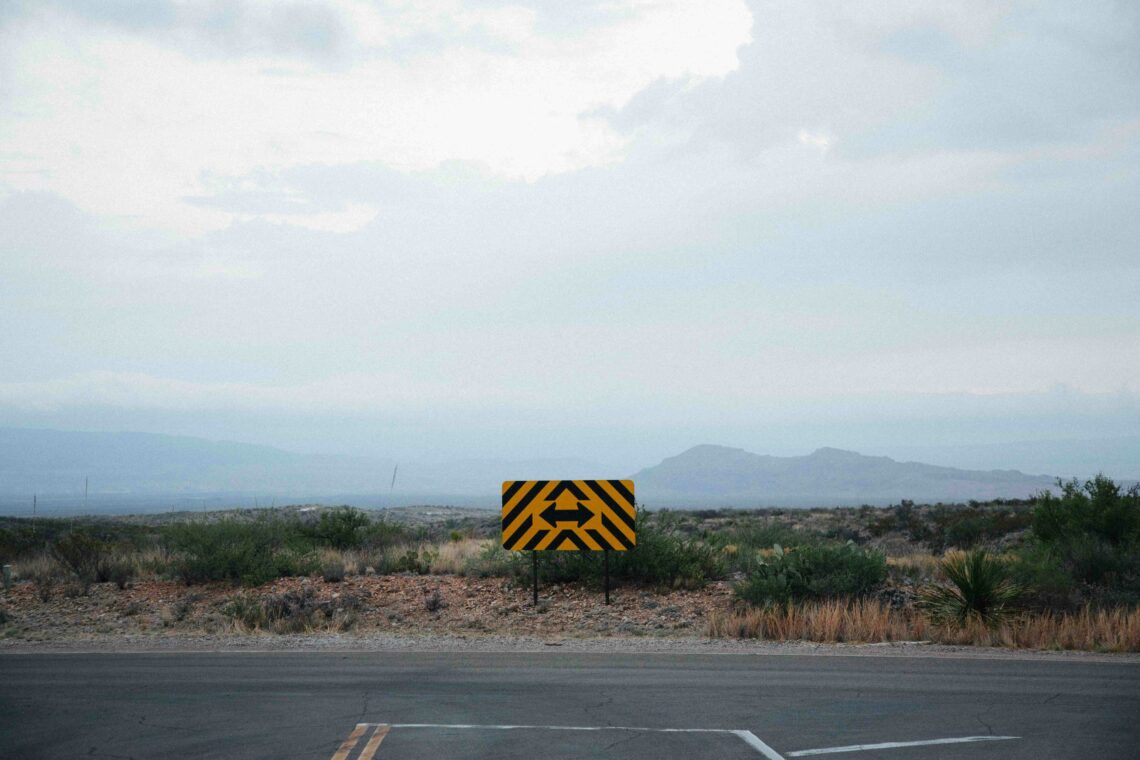 Crossroads sign representing the decision many long distance parents face of whether to give up a fulfilling life elsewhere to move back and be closer to their children.