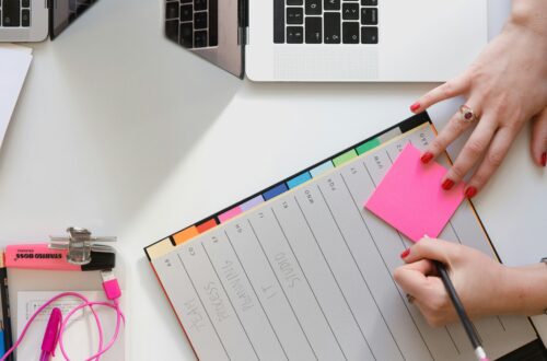 person writing in planner representing the importance of planning and getting a court order before becoming a long distance parent