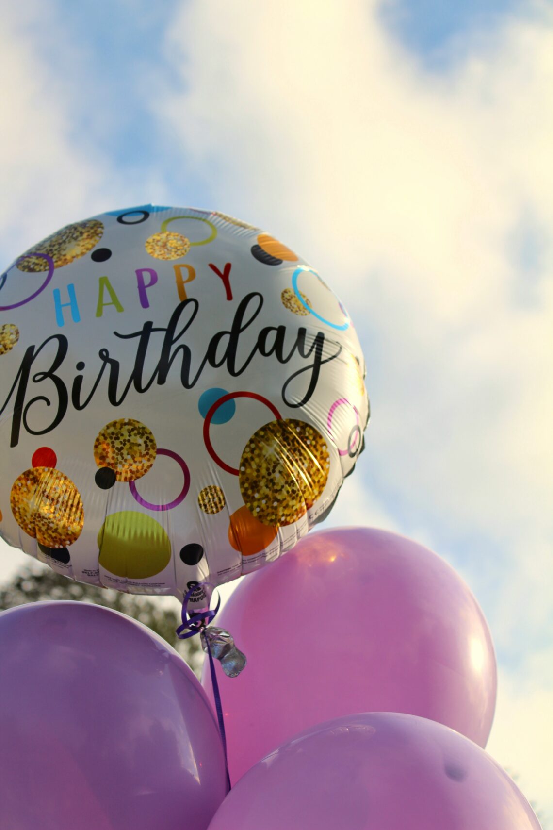 colorful birthday balloons representing a long distance parent celebrating their child's birthday from afar