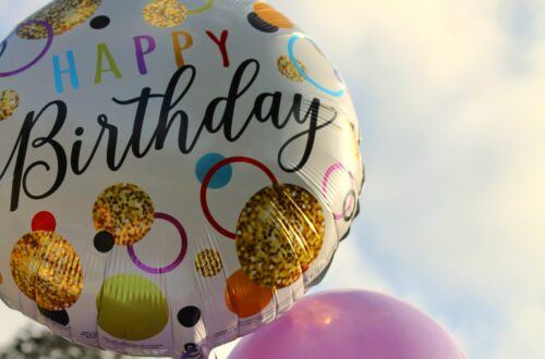 colorful birthday balloons representing a long distance parent celebrating their child's birthday from afar