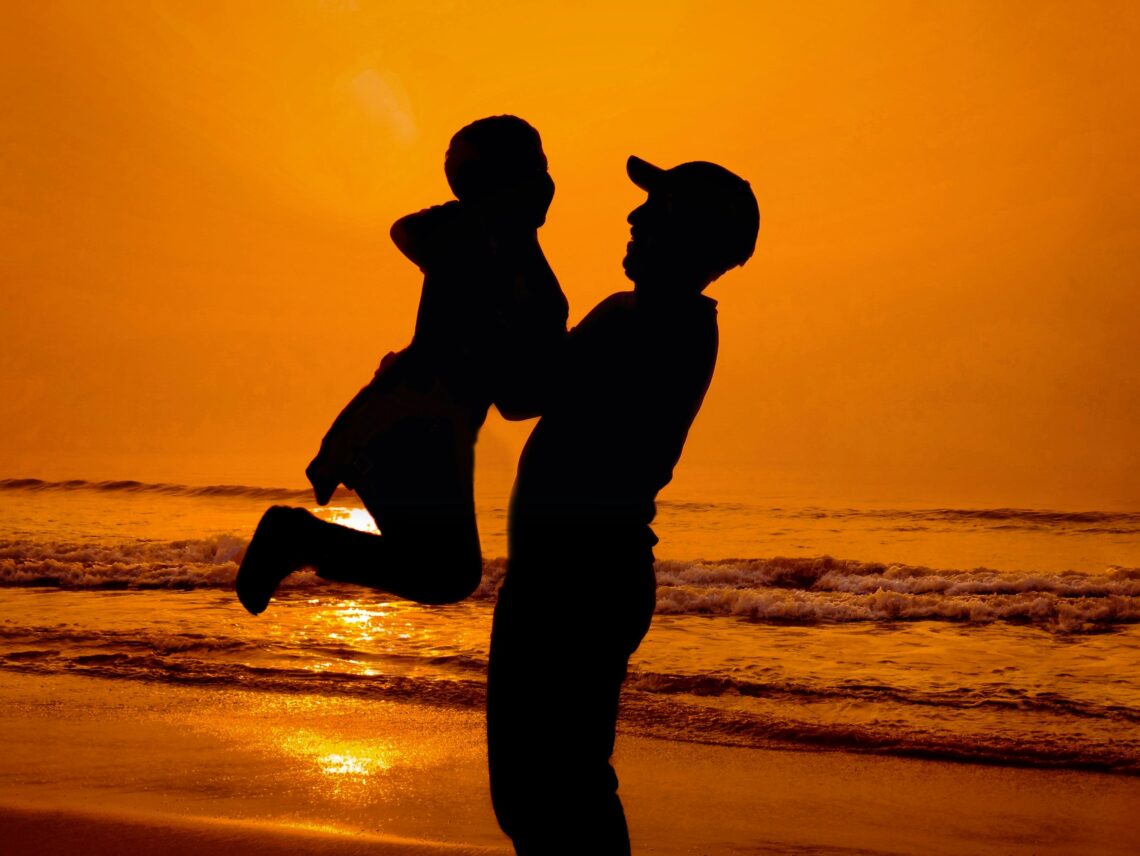 father and young son together representing the physical connection a long distance dad works to maintain across thousands of miles